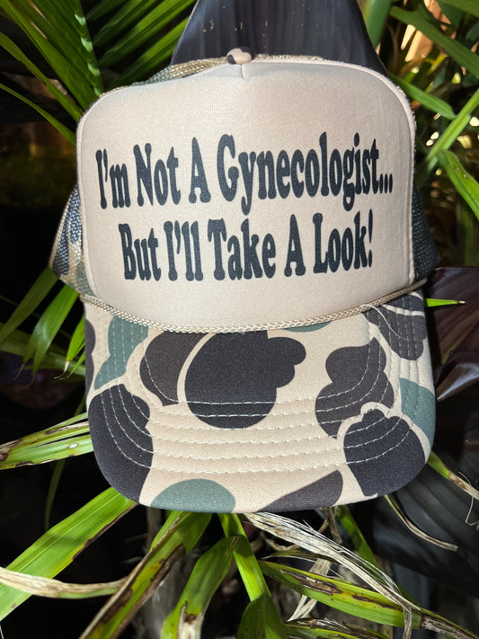 I'M NOT A GYNECOLOGIST BUT I'LL TAKE A LOOK Trucker Hat